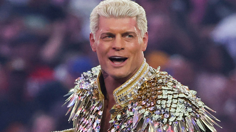 Cody Rhodes wearing a gold jacket