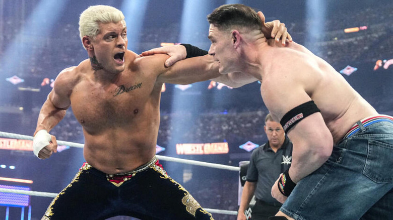 Cody Rhodes looks to strike John Cena with a right hand.