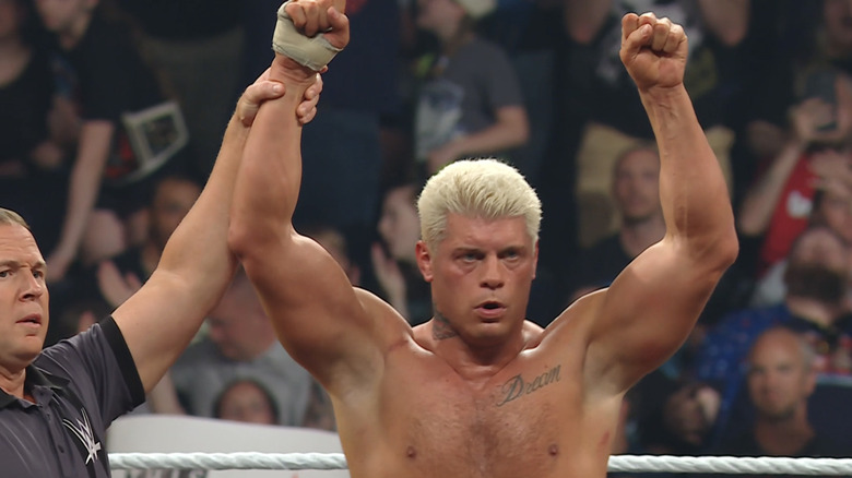 Cody Rhodes raises his hands following a victory.