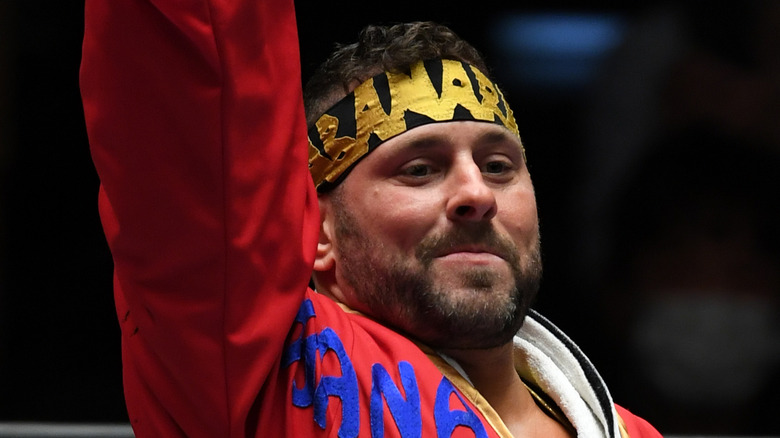 Colt Cabana with his arm raised inside a ring