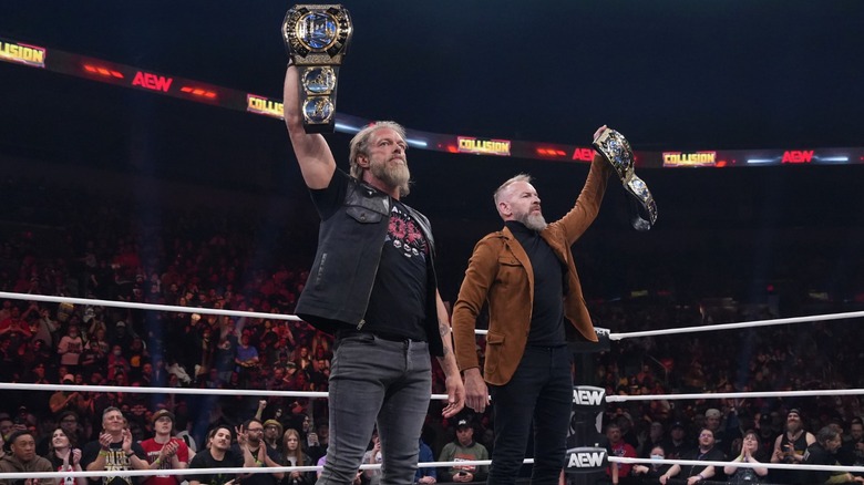 Adam Copeland and Christian Cage hoist tag team titles on 