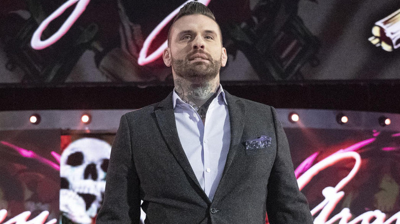 Corey Graves wearing a gray suit