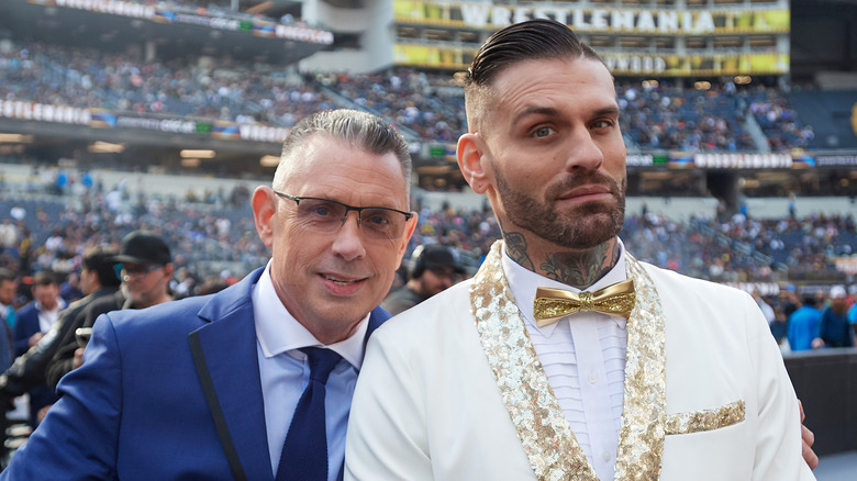 Corey Graves and Michael Cole posing