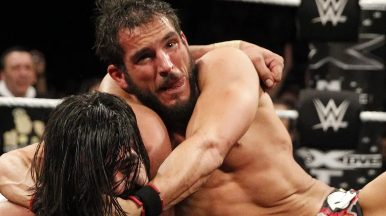 Johnny Gargano locks an opponent in a submission hold