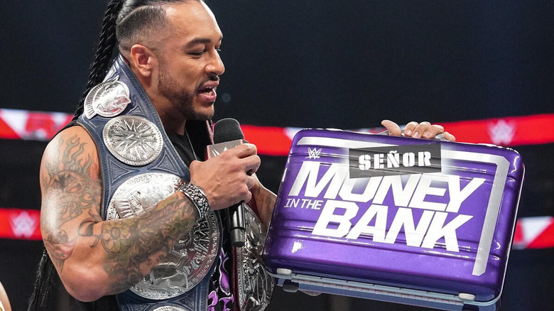 Damian Priest holding the men's Money in the Bank briefcase
