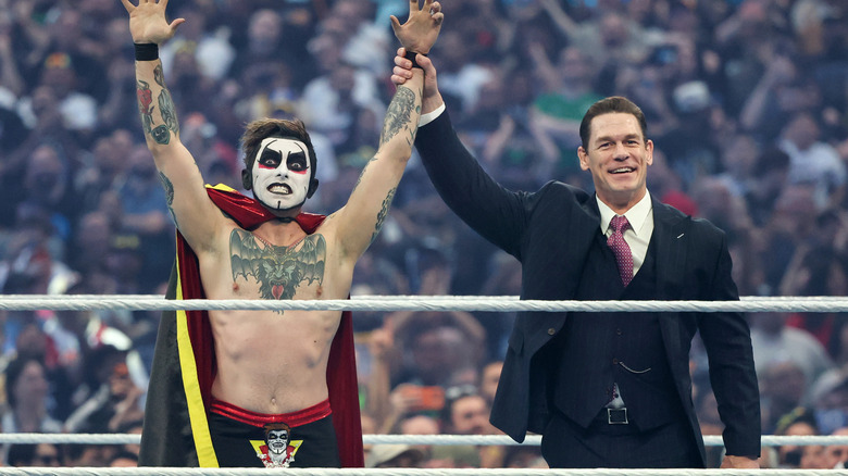 Host John Cena (R) lifts the hand of Danhausen during WrestleMania 42 at Allegiant Stadium on April 19, 2026 in Las Vegas, Nevada.