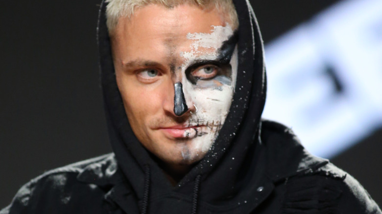 Darby Allin in a hoodie with smeared face paint on