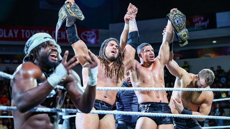 Darkstate pose in the ring following Osiris Griffin and Dion Lennox successfully regaining their NXT Tag Team Championships at Halloween Havoc.