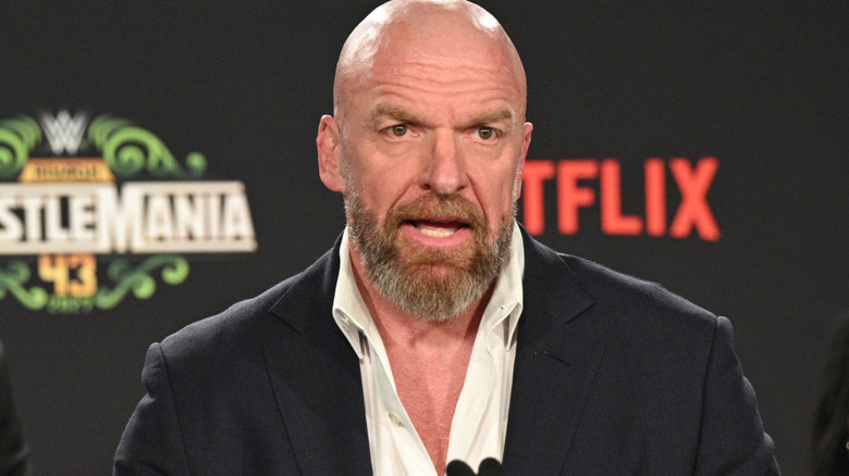Triple H is wearing a suit