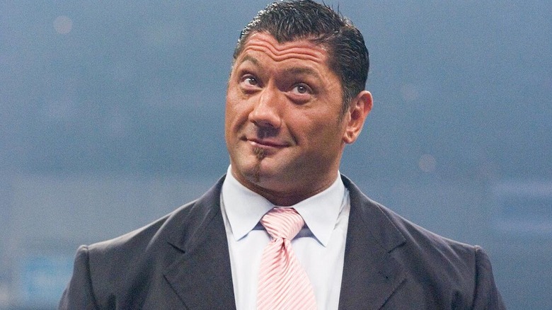 Batista wearing a suit during an in-ring WWE segment.