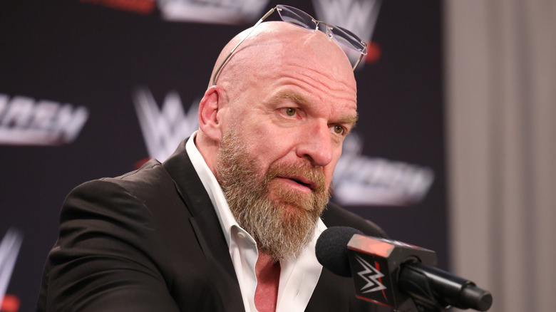 Triple H awaits a question from press during a media scrum