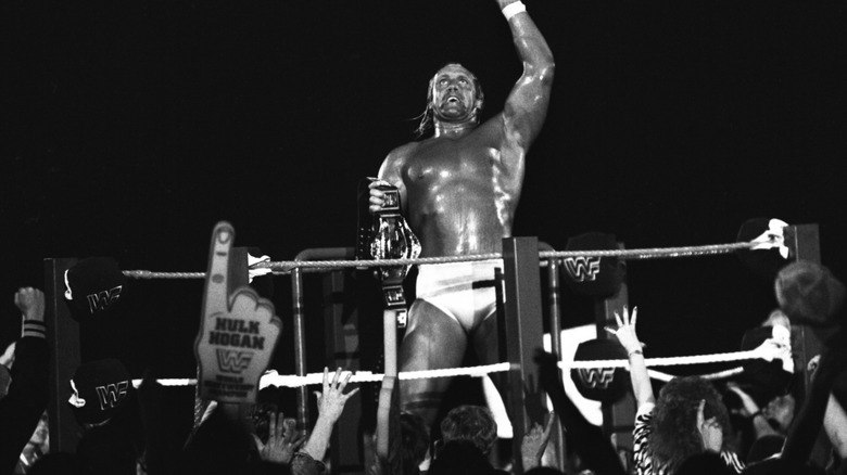 After winning the WWF Championship, Hulk Hogan poses with fans surrounding him