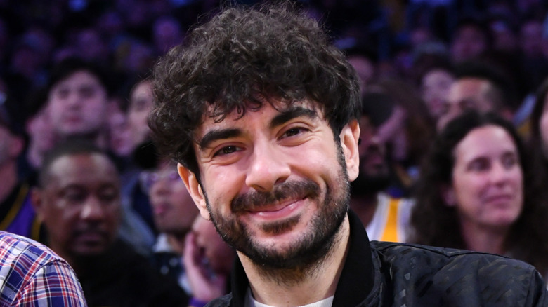 Tony Khan in the audience at a sporting event