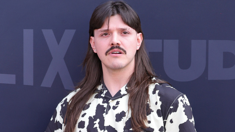 Dominilk Mysterio wearing a cow print shirt