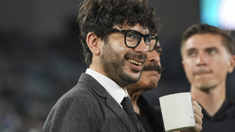 Tony Khan standing near his father, Shad Khan