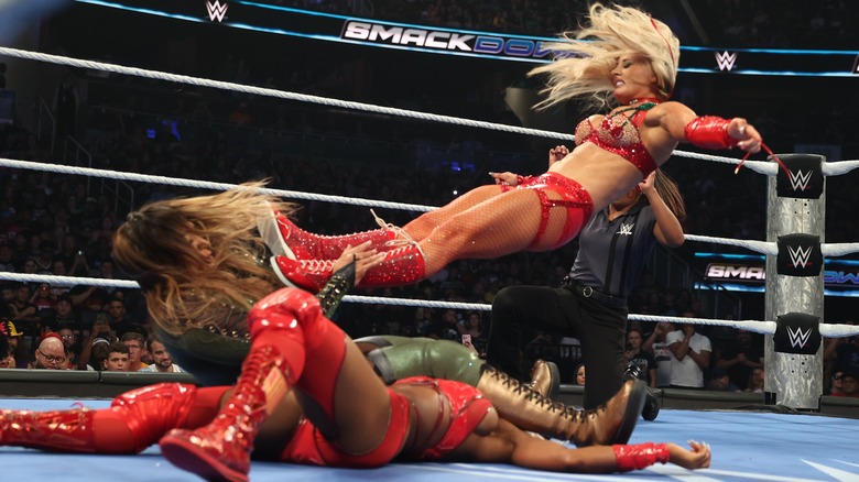 Tiffany Stratton hitting Nia Jax with a dropkick before she was able to pin Jade Cargill during their Triple Threat for the WWE Women's Championship.