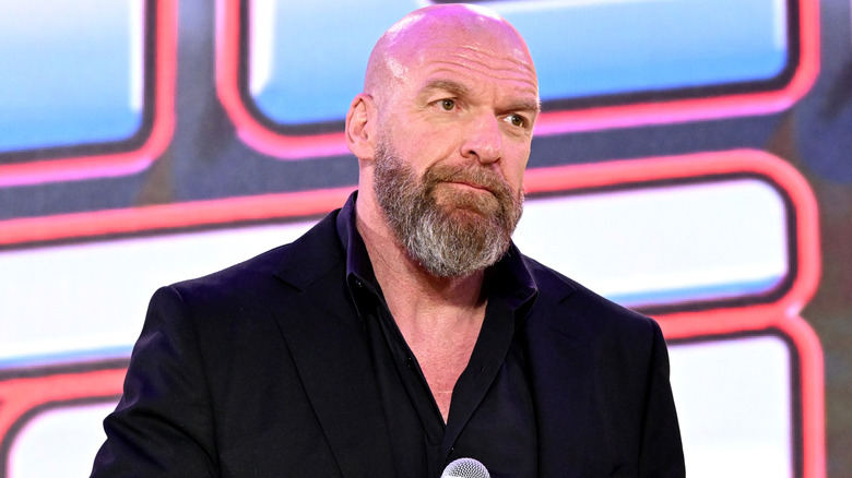 Triple H holding a microphone