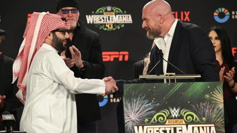 Paul Levesque shaking hands with Turki Al-Sheikh