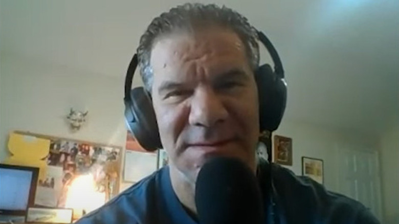 Dave Meltzer wears headphones
