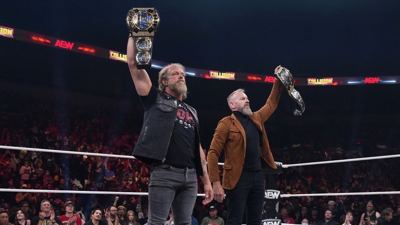 Adam Copeland and Christian Cage hoist tag team titles on 