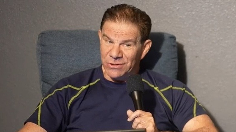 Dave Meltzer holding a microphone