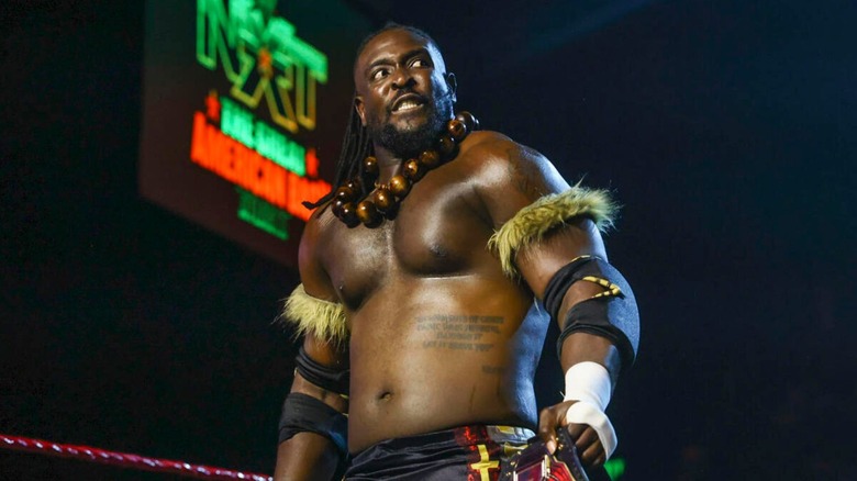 NXT Champion Oba Femi stands with the title in the ring ahead of a match at 