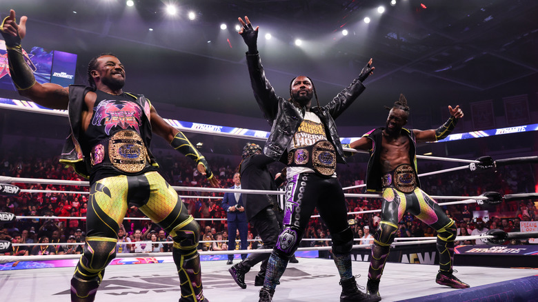 New Level's Kofi and Austin Creed pose alongside AEW World Trios Champion partner Swerve Strickland on the apron before their debut match on the September 2, 2026 edition of 