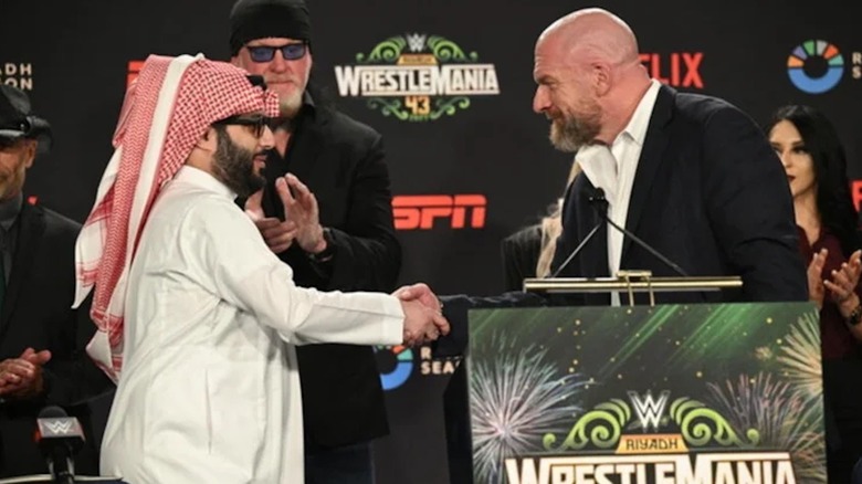 Paul Levesque shaking hands with Turki Al-Sheikh