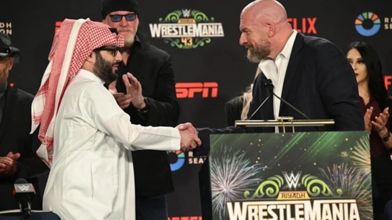 Paul Levesque shaking hands with Turki Al-Sheikh