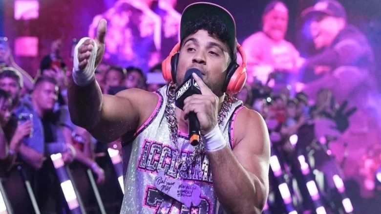 Max Caster raps his way down to the ring before a match on AEW programming.