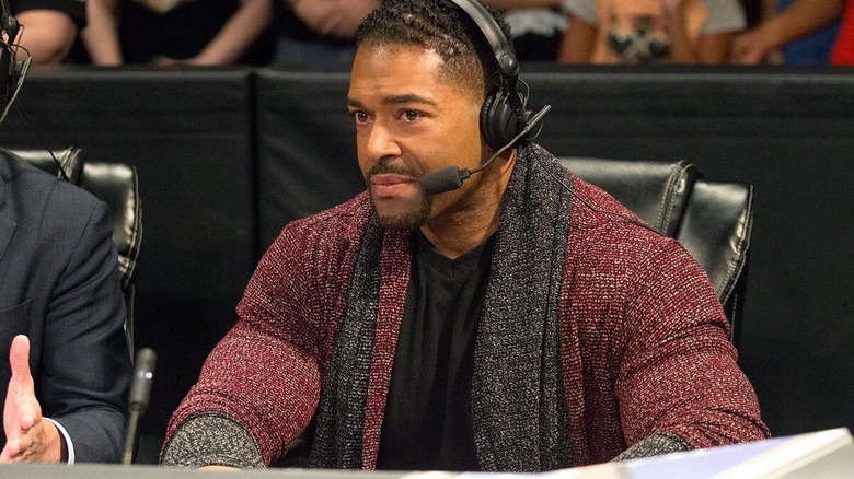 David Otunga ringisde on commentary during a live WWE show.