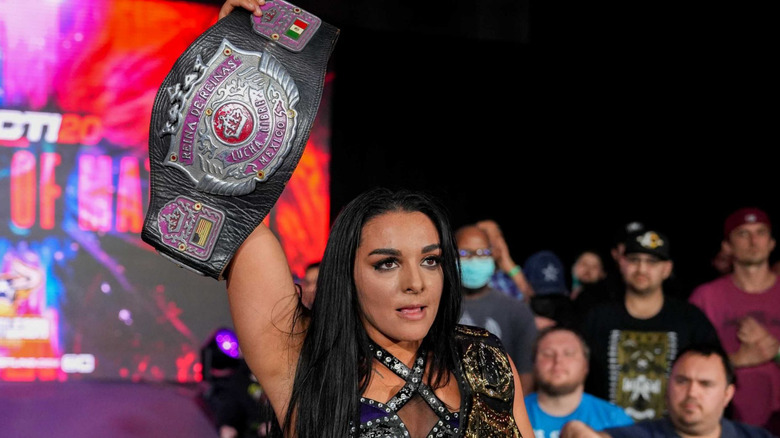 Deonna Purrazzo posing with her titles