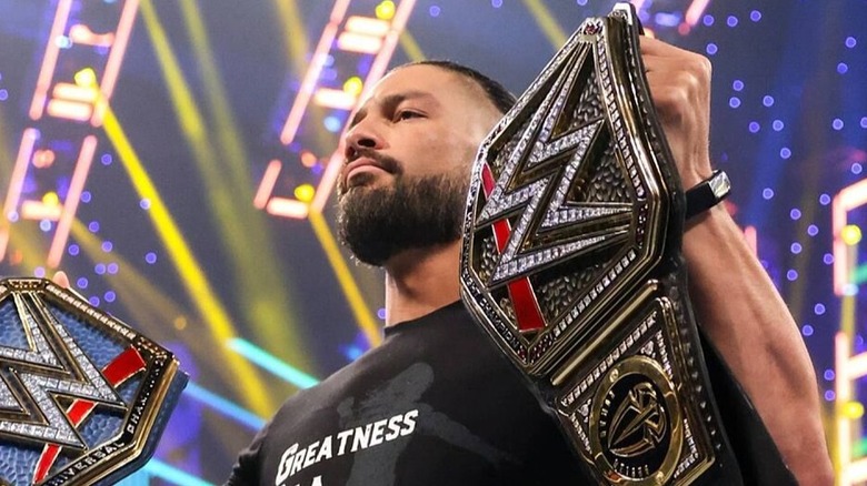 Roman Reigns Poses With His Titles