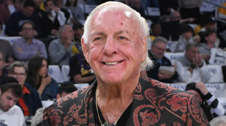 Ric Flair at a basketball game smiling