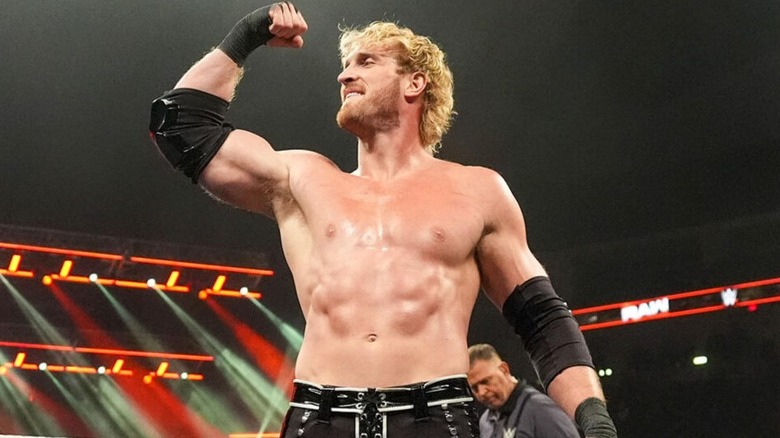 Logan Paul feels his oats by flexing his biceps during his scheduled match with Hall of Famer Rey Mysterio on "WWE Raw."