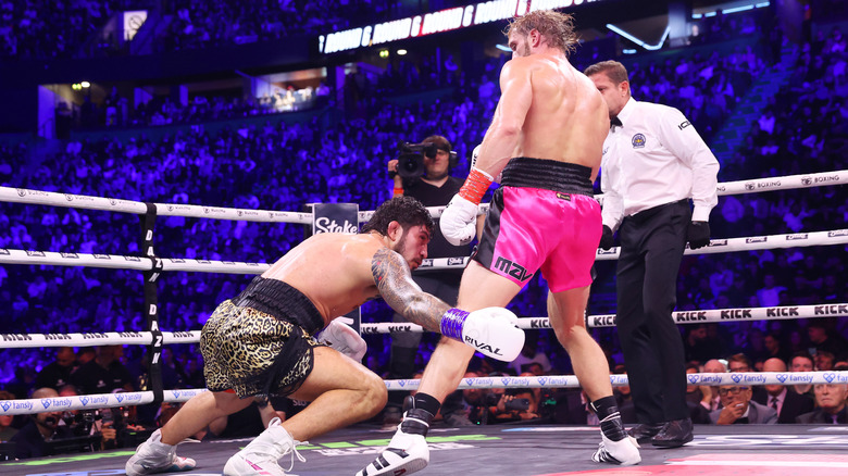 Dillon Danis dives at the feet of Logan Paul