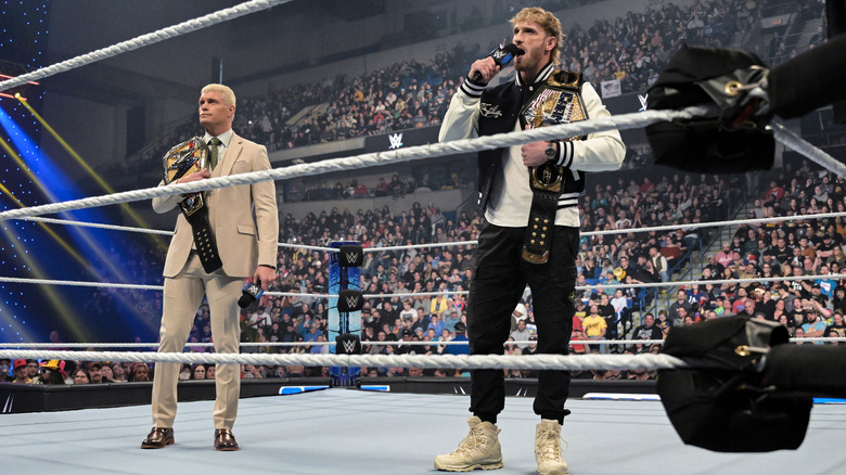 Cody Rhodes and Logan Paul stand with their title belts