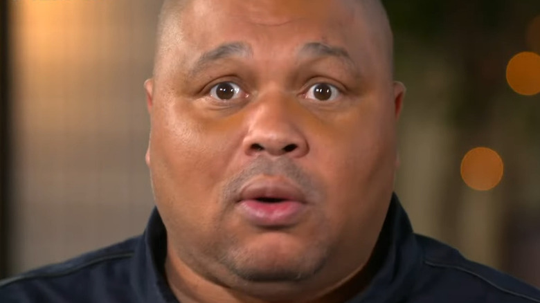 D'Lo Brown with a concerned expression on his face