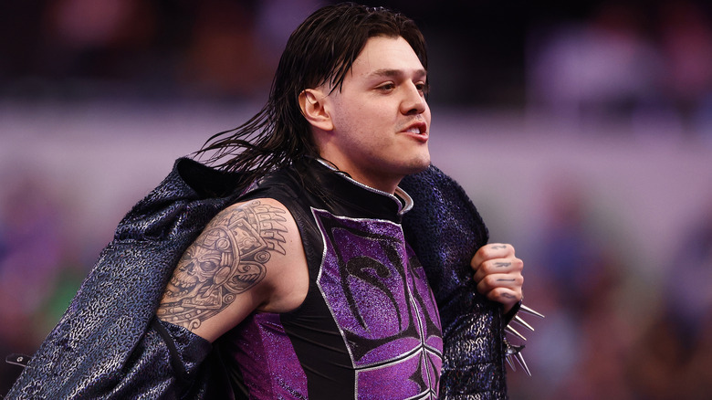 Dominik Mysterio taking off ring jacket