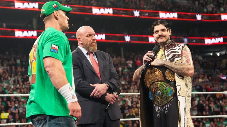 Dominik Mysterio flashes a cheeky grin at the crowd after dissing John Cena during a face-to-face confrontation on "WWE Raw."