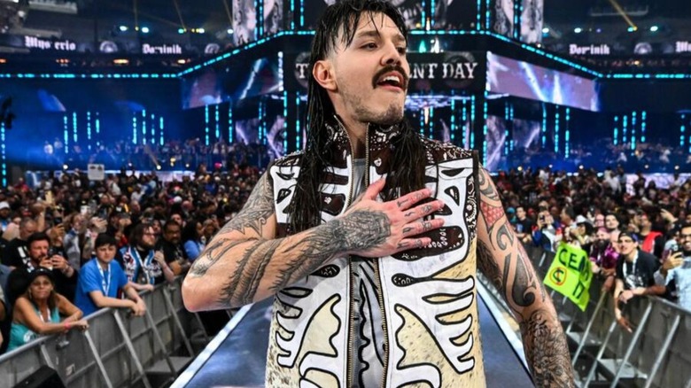 WWE's Dominik Mysterio poses on the ramp as he heads to the ring for a match.