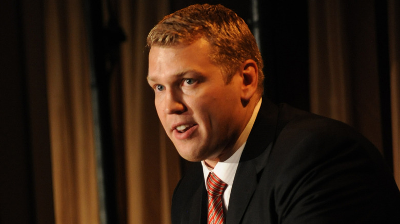 Chris Nowinski giving a speech in a suit