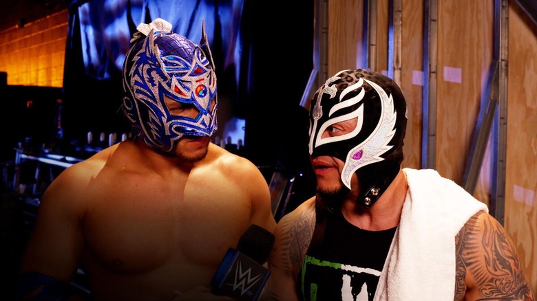 Rey Mysterio and Dragon Lee speak backstage.