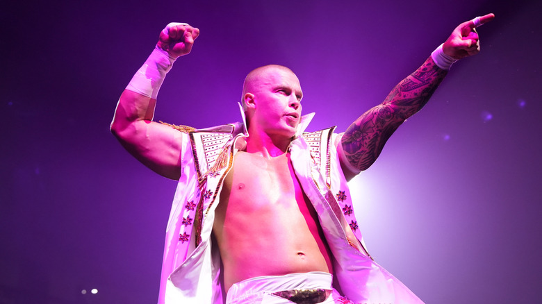 Kyle Fletcher posing in purple light