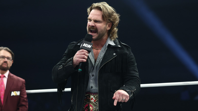 Hangman Adam Page speaking emphatically into a microphone on AEW Dynamite