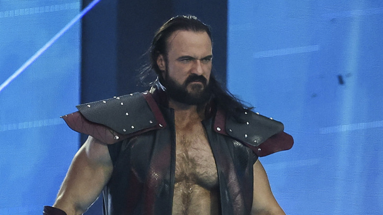 Drew McIntyre showing off his shoulder pads