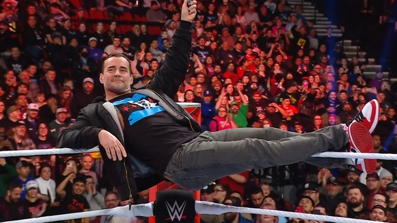 CM Punk lying across the top rope