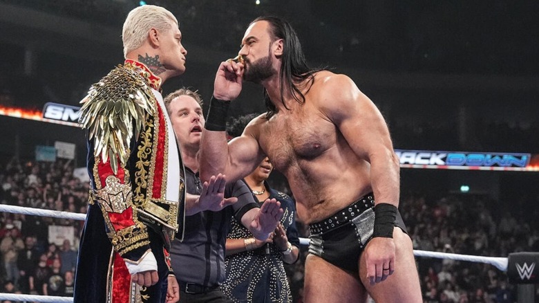 Drew McIntyre kisses Cody Rhodes' Rolex watch as he stares the then-champion down in the ring before their Three Stages of Hell match on 