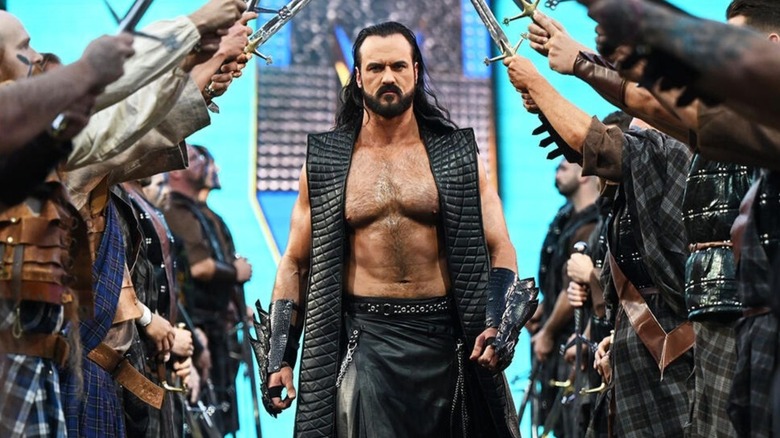 Drew McIntyre makes his way down to the ring, through a tunnel of swords created by men lining the ramp, ahead of his match at WWE WrestleMania 40.