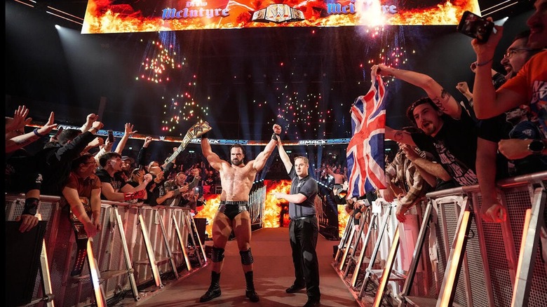 Drew McIntyre celebrates with the WWE title on 